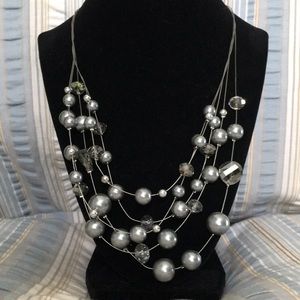 5 strands of metal with grey beads and glass facet-cut beads.